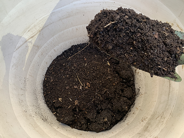 プランターへ堆肥と腐葉土を入れる